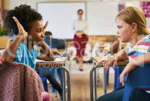 Bullying needs to be stopped. a young girl sitting in the classroom at school and bullying her classmate.