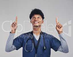 Act as if what you do makes a difference. It does. a male nurse pointing at copy space while standing against a grey background.