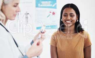 I cant wait to get my dose of protection. a doctor giving a patient an injection at a clinic.