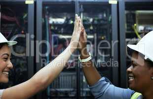 Problem solved. two attractive female programmers high fiving in a server room.