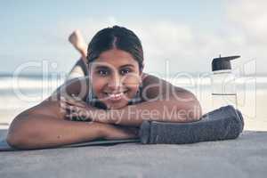 Yoga is one of my favorite forms of exercise. a sporty young woman lying on her yoga mat at the beach.