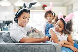 Time spent with bunnies is never wasted. a young woman playing a rabbit at home.