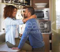 If we carry on well never get dinner done. Shot of a young couple sharing a romantic moment in the kitchen.