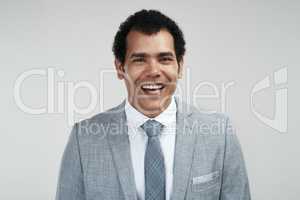 Maintaining a positive attitude is whatll help you succeed. Studio shot of a confident businessman standing against a grey background.