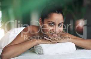 This is a place of bliss. Portrait of a young woman lying on a massage bed at a spa.