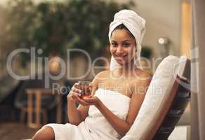 They sure know how to make you feel like royalty here. a woman drinking tea while enjoying a spa day.