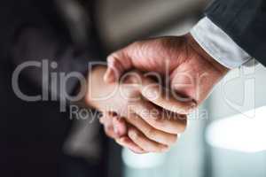 Once we shake hands , the deal is made. two unrecognizable businesspeople shaking hands in an office.