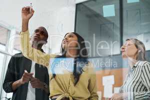 Naturally submissive to who we trust to lead. a group of businesspeople brainstorming in a modern office.