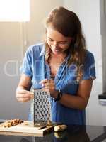 If youre tired of starting over, stop giving up. an young woman preparing a healthy meal at home.