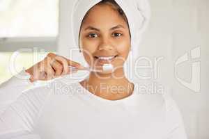 Lying through your teeth does not count as flossing. a beautiful young woman brushing her teeth in the morning.