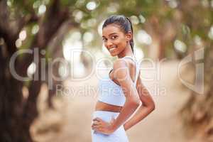 Take a look at the fruits of my labour. a young woman getting ready for a jog outdoors.