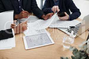 Planning the way to boosted profits. a group of unrecognisable businesspeople having a meeting in a modern office.
