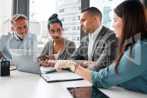 They always figure our the best way forward as a team. a group of businesspeople having a meeting in an office.