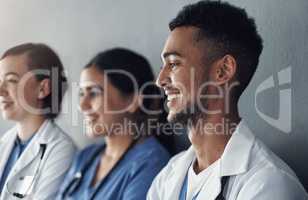 Always remember the privilege it is to be a physician. a group of doctors standing against a grey background at work.