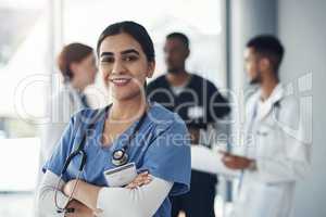 Only a life lived for others is a life worthwhile. a young female doctor standing in the office of a hospital.