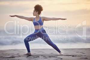 Lack of meditation leaves ignorance. a young female doing yoga on the beach.