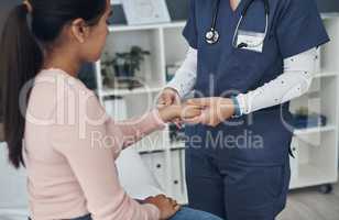 Ill be very gentle. a unrecognizable doctor checking a patients wrist in an office.