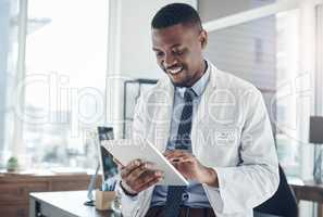 The transformation of the medical field digitally. a young doctor using a digital tablet in an office.