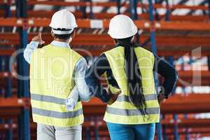 We can utilise this space. two unrecognizable contractors standing together in the warehouse and observing the layout.