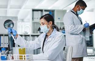 Making a difference through research. two young researchers working in a laboratory.