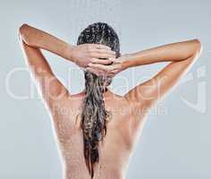 Now for a thorough rinse. a young woman taking a shower.