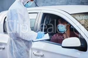 Have you been infected with the virus. a doctor recording a patients information for a drive through vaccination.