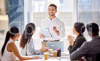 I have just the plan to reach great success. a young businessman leading a meeting with his colleagues in an office.