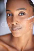 I love my skin. Closeup portrait of an attractive young woman using a dropper to apply serum to her face.