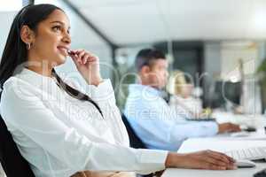 I suppose you could do that. a young call centre agent sitting in the office and looking contemplative while wearing a headset.