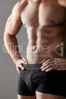 A champion is someone who gets up when they cant. Studio shot of a unrecognizable muscular man posing against a grey background.