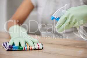 Time to get squeaky clean. an unrecognizable woman using a cloth and spray bottle to clean the surfaces at home.