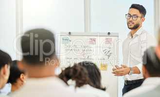 He gives the best presentations. a handsome young businessman giving a presentation in the conference hall.