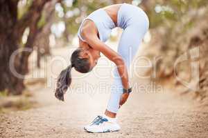 There wont be any injuries on my watch. a woman stretching before a run outdoors.