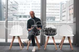 Kingdom above the weather, willing to wait to get there. a young businessman sitting in an office.