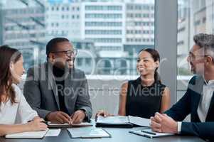 Meetings keep everyone focused and productive. a group of corporate business colleagues having a meeting around the table in the boardroom.