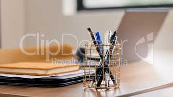 Make sure your pens are easy to find. Still life shot of a pen holder full of pens on a desk in an office.