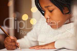 Art is her favourite subject. a little girl drawing at home.