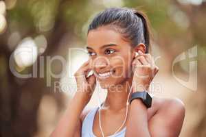 Ive been saving this playlist for this moment. a young woman listening to music while jogging.