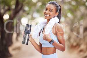 Replace the water you lose through sweating. a young woman taking a break to drink some water during a jog.