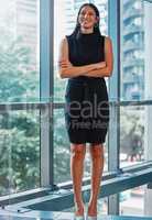 Commit to your career. Portrait shot of a young businesswoman standing with her arms crossed at work.