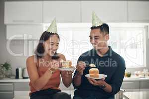 The cake is amazing. a young couple eating cake at home.