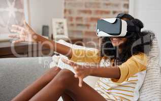 Who needs friends. a young girl playing with a vr headset at home.