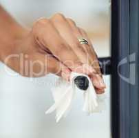 If you touched it, Im cleaning it. an unrecognizable woman wiping a door handle.