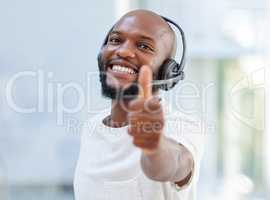 Such a good day is deserves a thumbs up. a young businessman working in a call center.