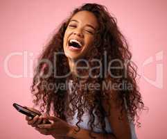 Id scroll through memes all day. Studio shot of a beautiful young woman using her cellphone while standing against a pink background.