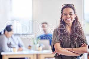 Be confident in your pursuit of success. a young female businesswoman standing with her arms crossed in an office at work.