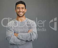 The best thing you can do is to smile. a handsome young man standing against a grey background.