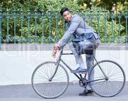 Reduce your carbon footprint. a young businessman riding a bike in the city.