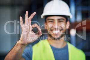 Were 100 safety compliant. Portrait of a young man working showing an okay gesture at a construction site.