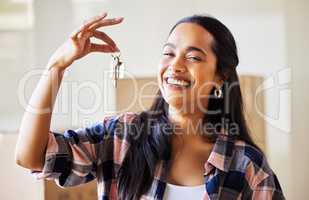 This is a chance to create new memories. a young woman showing the keys to her new home.